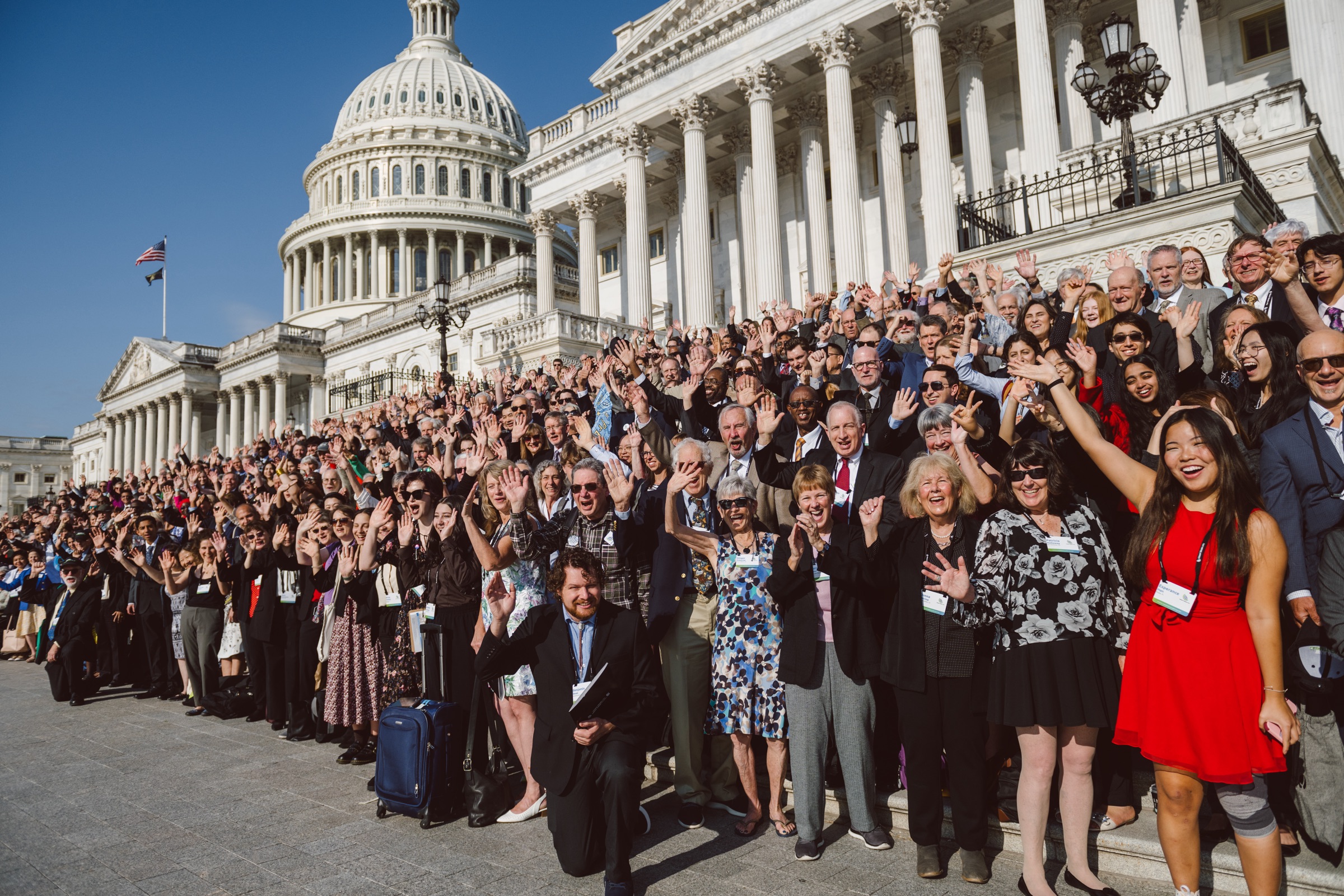 Hundreds of cheering CCL volunteers waving in front of the U.S. Capitol on Lobby Day