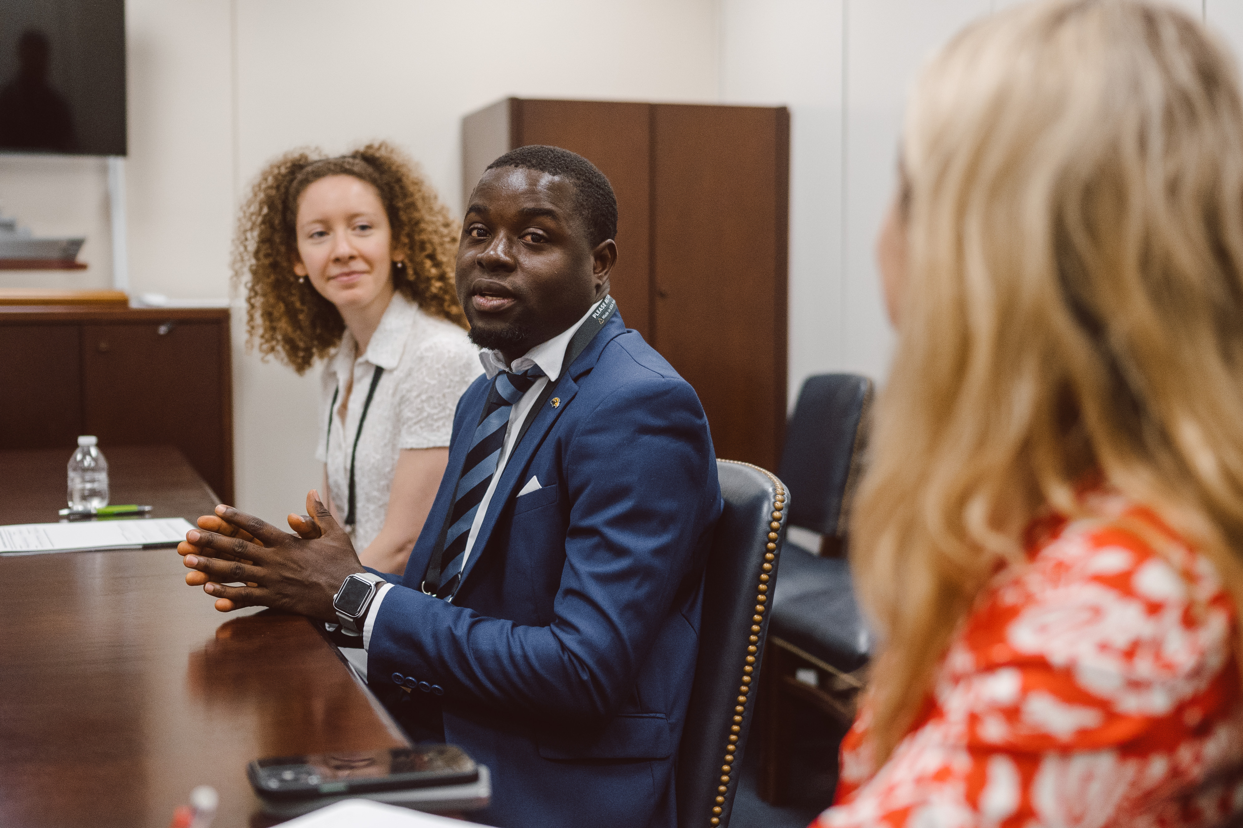 A CCL volunteer speaking in a meeting with a congressional office