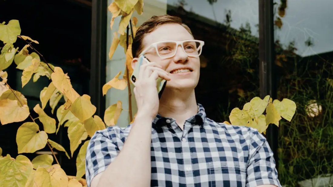 A volunteer on the phone outside on an autumn day