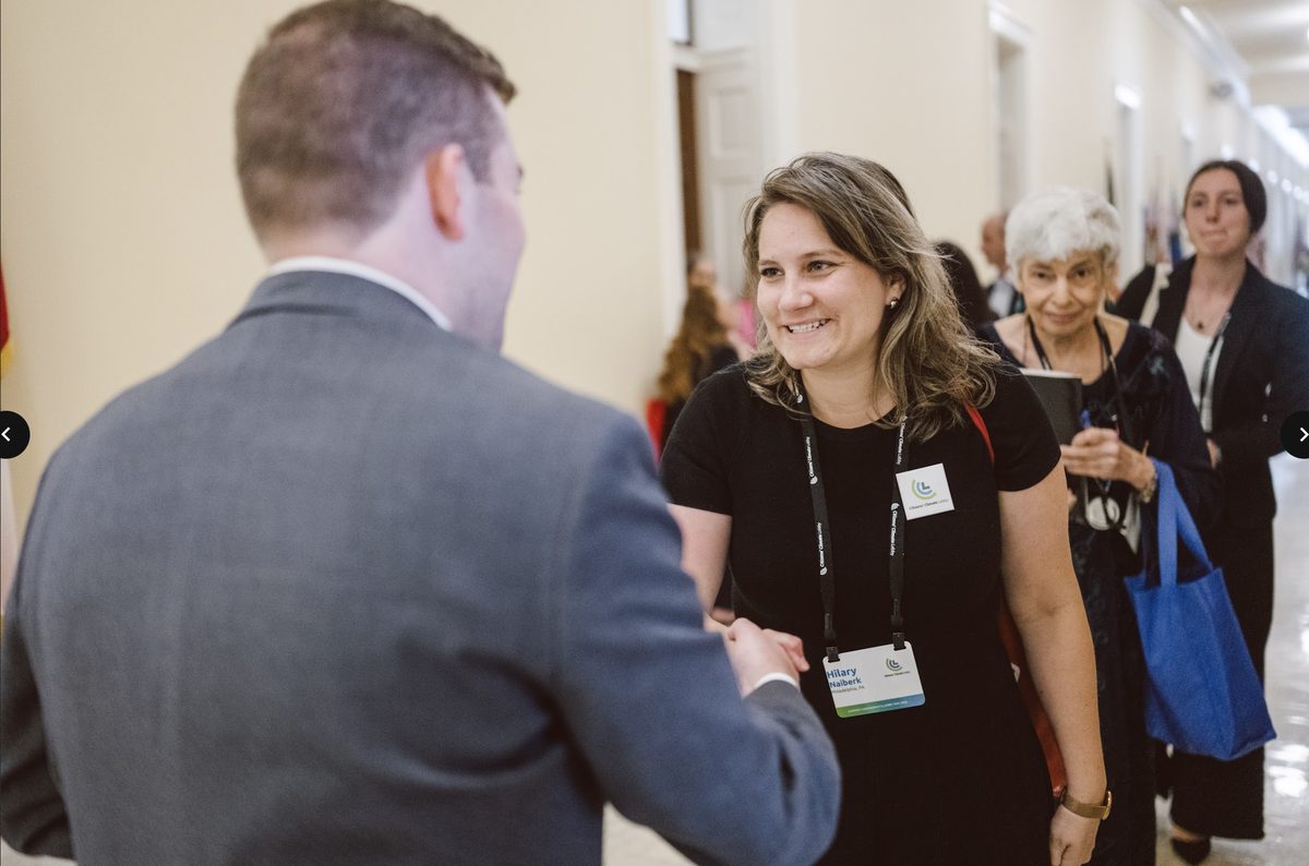A volunteer in conversation with a congressional staffer at a CCL conference