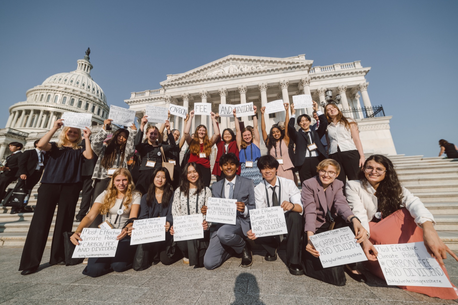 Virginia CCL volunteers on the Capitol steps holding hand-lettered carbon fee and dividend signs